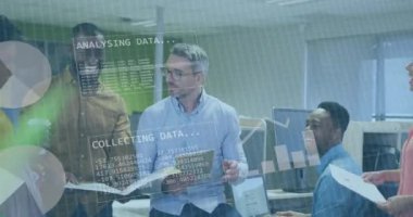 Animation of financial data processing over diverse business people working in office. Global business, finances, computing and data processing concept digitally generated video.