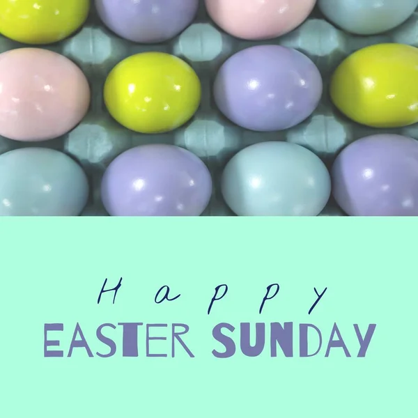 Image of happy easter sunday text over easter eggs in box. Easter sunday and celebration concept digitally generated image.