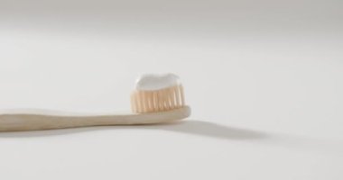 Diş fırçasını beyaz arka planda diş macunu ve fotokopi alanı ile kapat. Plastiksiz güzellik ve ekolojik ambalaj kavramı.