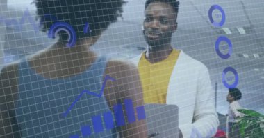 Animation of financial data processing over diverse business people working in office. Global business, finances, computing and data processing concept digitally generated video.