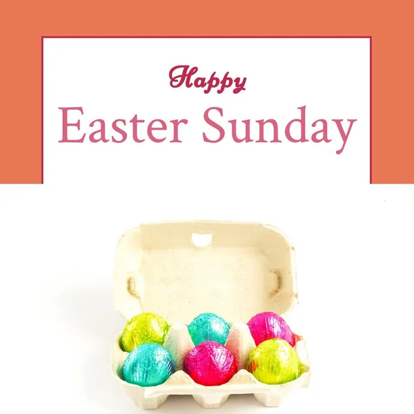 Image of happy easter sunday text over chocolate easter eggs in box. Easter sunday and celebration concept digitally generated image.