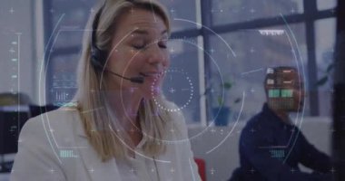 Animation of financial data processing over diverse business people working in office. Global business, finances, computing and data processing concept digitally generated video.