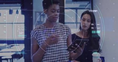 Animation of financial data processing over diverse businesswomen in office. Global business, finances, computing and data processing concept digitally generated video.