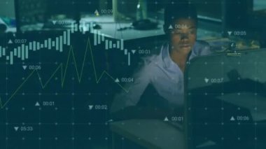 Animation of data processing over african american businesswoman working in office. Global business and digital interface concept digitally generated video.