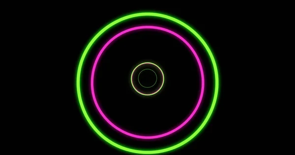 Image of green and pink neon circles on black background. Neon, light and movement concept digitally generated image.