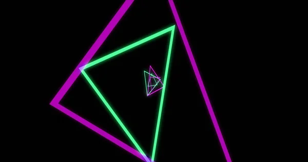Image of green and pink neon triangles on black background. Neon, light and movement concept digitally generated image.