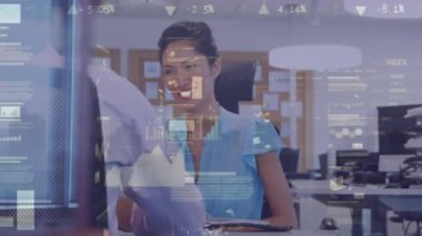 Animation of financial data processing over biracial businesswoman in office. Global business, finances, computing and data processing concept digitally generated video.