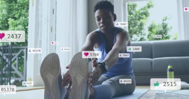 Animacja Ikon Mediów Społecznościowych Liczb Nad Afrykańską Amerykanką Ćwiczącą Domu — Wideo stockowe