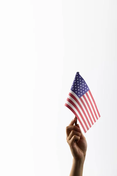 Hand holding flag pole of usa on white background with copy space. Memorial day, patriotism and celebration concept.