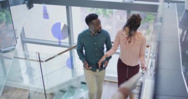 Animation of data processing over diverse business people in office. Global business, finances, computing and data processing concept digitally generated video.