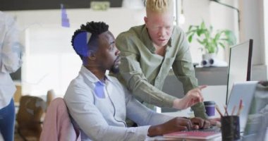 Animation of data processing over diverse business people in office. Global business, finances, computing and data processing concept digitally generated video.