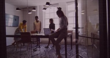 Animation of financial data processing over diverse business people in office. Global business, finances, computing and data processing concept digitally generated video.