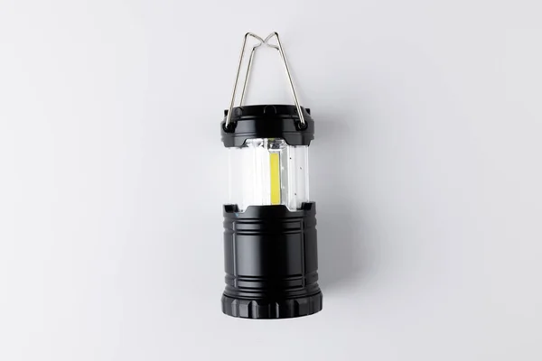 Close up of black camping lamp on white background with copy space. National camping month, equipment and celebration concept.