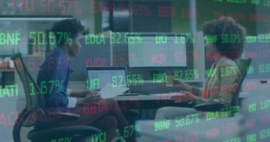 Animation of financial data processing over diverse businesswomen in office. Global business, finances, computing and data processing concept digitally generated video.