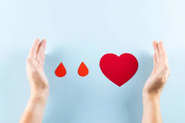 Hands Caucasian Woman Protecting Blood Drops Heart Blue Background Blood — Stock Photo, Image