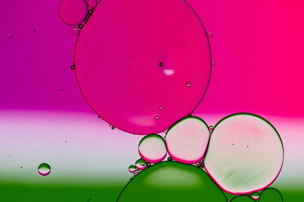 Macro close up of water bubbles with copy space over pink background. Macro, colour, water, shape and pattern concept.