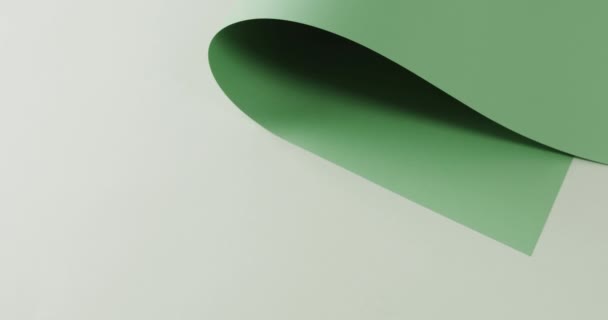 Закрыть Зеленый Свернутый Лист Бумаги Белом Фоне Копированием Пространства Замедленной — стоковое видео
