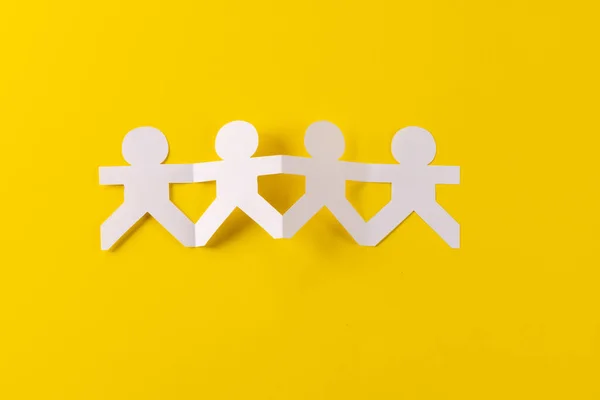 Close Four Paper Cut Out People Figures Holding Hands Copy — Stock Photo, Image