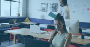 Animation of financial data processing over diverse business people in office. Global business, finances, computing and data processing concept digitally generated video.