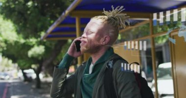 Şehirde akıllı telefon kullanan Afrikalı Amerikalı albino adamın veri işleme animasyonu. Küresel teknoloji, bilgisayar ve veri işleme kavramı dijital olarak oluşturulmuş video.