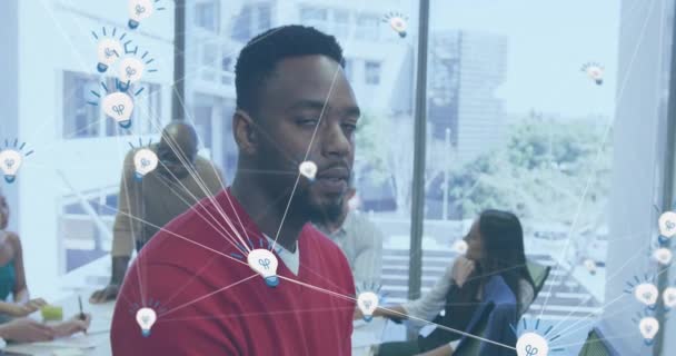 Анимация Сети Иконы Лампочки Против Африканского Американца Улыбающегося Офисе Концепция — стоковое видео