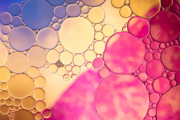 Macro close up of water bubbles with copy space over multi coloured background. Macro, colour, water, shape and pattern concept.