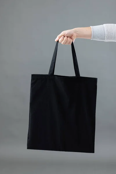 Hand Caucasian Woman Holding Black Canvas Bag Copy Space Grey — Stock Photo, Image
