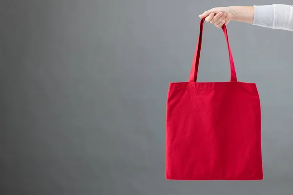Hand Caucasian Woman Holding Red Canvas Bag Copy Space Grey — Stock Photo, Image