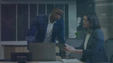 Animation of data processing over diverse businessman and businesswoman discussing at office. Business data technology concept