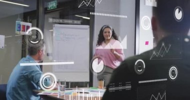 Animation of financial data processing over diverse business people in office. Global business, finances, computing and data processing concept digitally generated video.