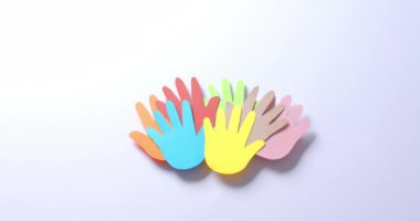 Beyaz arkaplanda fotokopi alanı olan renkli kağıtlardan yapılmış elleri birleştirin. Topluluk, küresel, insanlar ve sanat.