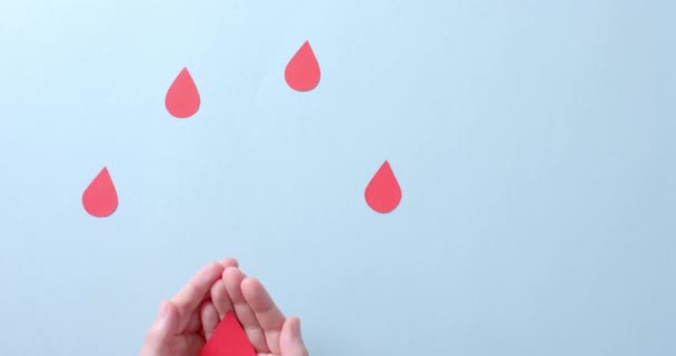 Hands Caucasian Woman Holding Blood Drop Drops Blue Background Slow — Stock Video