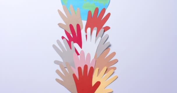 Close Hands Together Globe Made Colourful Paper White Background Copy — Stock Video