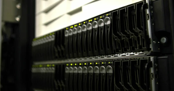Close up of server device in server room over blurred background. Global technology and security.