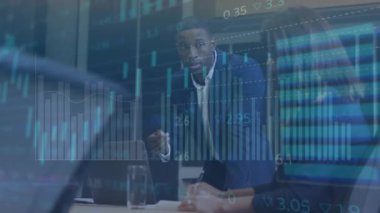 Animation of data processing over diverse businessman and businesswoman discussing at office. Business data technology concept