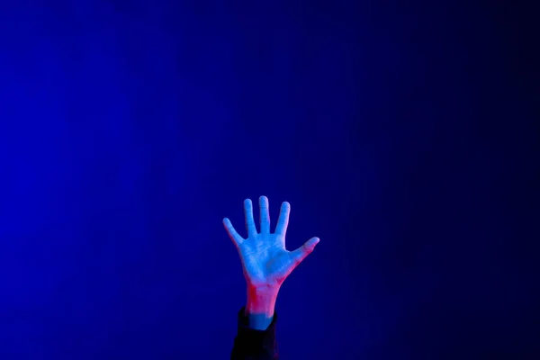 Stock image Exposed open hand in studio with blue light with copy space. Virtual reality and digital interface technology.