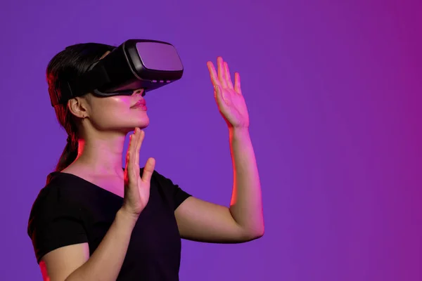 紫色の光とコピースペースのスタジオでVrヘッドセットを使用してアジアの女性 仮想現実とデジタルインターフェース技術 — ストック写真