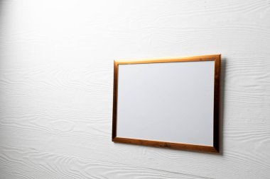 Beyaz duvarında kopya alanı olan kahverengi boş çerçeve. Çerçeve şablonu, iç tasarım ve dekorasyonu düzenle.