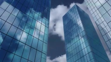 Gökyüzündeki bulutlara karşı alçak açılı binaların animasyonu. İş teknolojisi kavramı