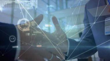 Animation of network of connections over mid section of two businessmen shaking hands at office. Global networking and business technology concept