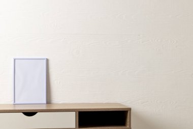 Beyaz duvarda fotokopi masası olan boş bir çerçeve. Çerçeve şablonu, iç tasarım ve dekorasyonu düzenle.