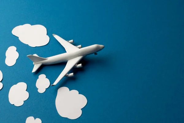 stock image Close up of airplane model with clouds on blue background with copy space. Travel, transport and vacation.