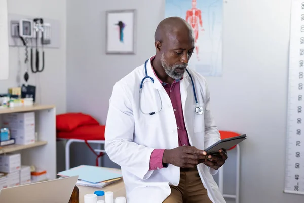 African American Male Doctor Wearing Stethoscope Using Tablet Doctor Office — Stock Photo, Image