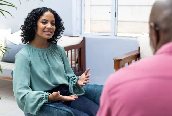 stock image Happy biracial female patient attending therapy with african american male therapist. Mental health, therapy and counselling.