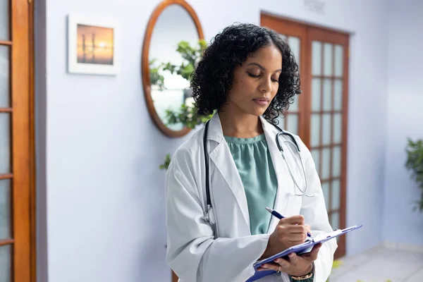 Biracial Female Doctor Wearing Stethoscope Holding Clipboard Taking Notes Doctor — Stock Photo, Image