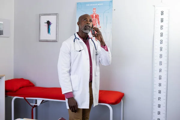 African American Male Doctor Wearing Stethoscope Talking Smartphone Doctor Office — Stock Photo, Image