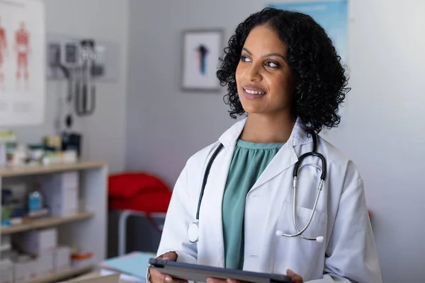 Happy Biracial Female Doctor Wearing Sthethoscope Using Tablet Doctor Office — Stock Photo, Image