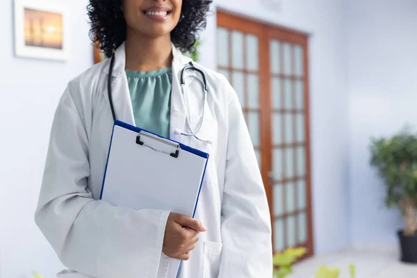 Biracial Female Doctor Wearing Stethoscope Holding Clipboard Smiling Doctor Office — Stock Photo, Image