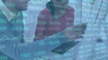 Animation of financial data processing over diverse business people in office. Global business, finances, computing and data processing concept digitally generated video.