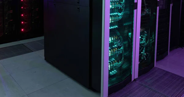 Glowing computer servers in a dark computer server room. Communication, data and digital technology, digitally generated image.